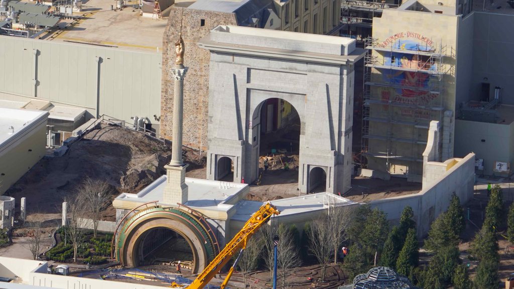 construction of Epic Universe's  Porte Saint-Denis arch with mural to the right 