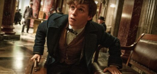 A video still of Newt Scamander clutching his iconic briefcase.