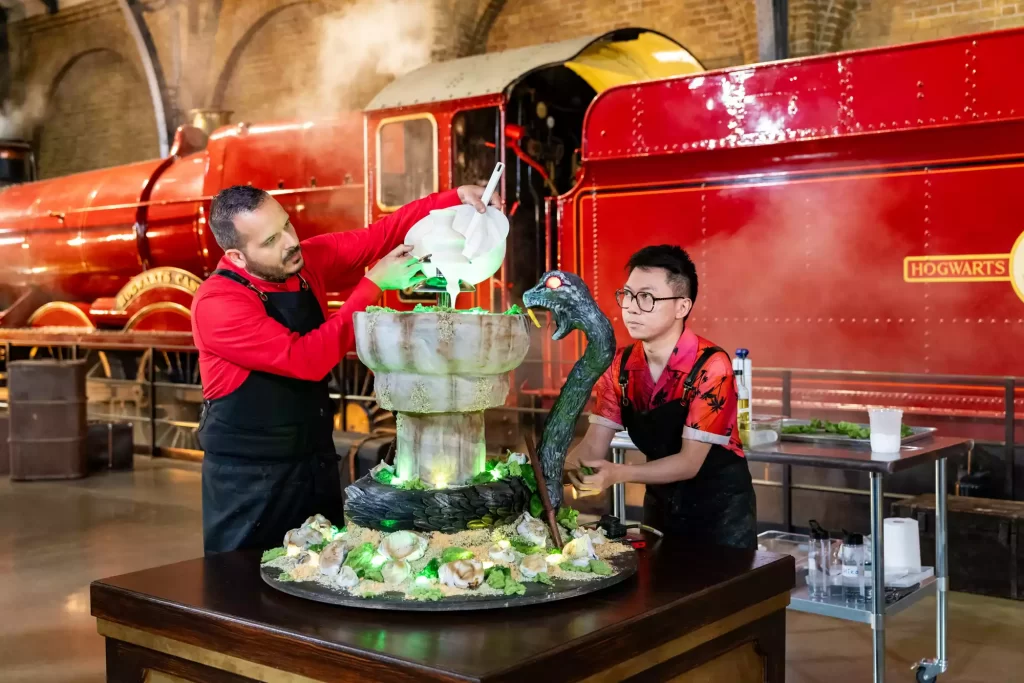 Bakers in front of the Hogwarts Express at the Studio Tour (Credit: Food Network).