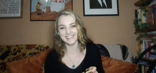 Evanna Lynch smiling widely on couch